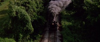 Movie still from “Biloxi Blues” (1988), directed by Mike Nichols – An aerial view of a steam train going down the tracks; Extreme Wide shot, High angle