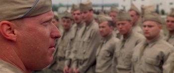 Movie still from “Biloxi Blues” (1988), directed by Mike Nichols – A group of men standing in a line in front of each other; Close Up shot, Over the shoulder angle