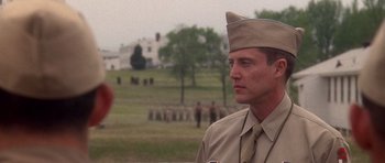 Movie still from “Biloxi Blues” (1988), directed by Mike Nichols – A man in a military uniform is standing in front of a crowd; Close Up shot, Low angle