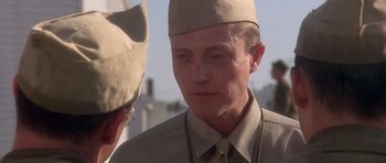 Movie still from “Biloxi Blues” (1988), directed by Mike Nichols – A person wearing a hat; Close Up shot, Over the shoulder angle