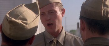 Movie still from “Biloxi Blues” (1988), directed by Mike Nichols – A person wearing a uniform; Close Up shot, Over the shoulder angle