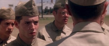 Movie still from “Biloxi Blues” (1988), directed by Mike Nichols – A group of men in military fatigues are looking at each other; Close Up shot, Over the shoulder angle