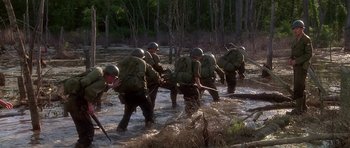 Movie still from “Biloxi Blues” (1988), directed by Mike Nichols – A group of men in the water with a stick; Wide shot, High angle