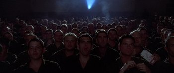 Movie still from “Biloxi Blues” (1988), directed by Mike Nichols – A large group of men standing in front of a projector; Medium shot, Low angle