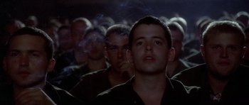 Movie still from “Biloxi Blues” (1988), directed by Mike Nichols – A group of men standing next to each other in a room; Close Up shot, Low angle