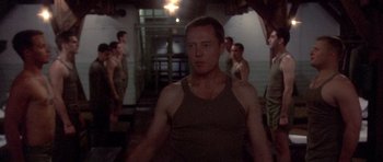 Movie still from “Biloxi Blues” (1988), directed by Mike Nichols – A group of men standing in a room; Medium shot, Low angle