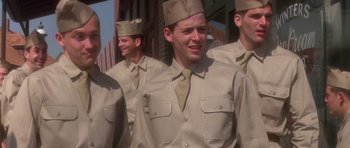 Movie still from “Biloxi Blues” (1988), directed by Mike Nichols – A group of men in uniform standing next to each other; Medium shot, Low angle