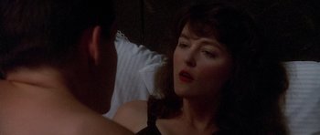 Movie still from “Biloxi Blues” (1988), directed by Mike Nichols – A woman sitting in front of a man in a bed; Close Up shot, Over the shoulder angle