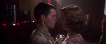 Movie still from “Biloxi Blues” (1988), directed by Mike Nichols – A man and a woman are kissing in a dark room; Close Up shot, Low angle