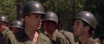 Movie still from “Biloxi Blues” (1988), directed by Mike Nichols – A group of men in military uniforms standing next to each other; Close Up shot, Over the shoulder angle
