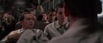 Movie still from “Biloxi Blues” (1988), directed by Mike Nichols – A group of men sitting on a train; Close Up shot, Over the shoulder angle