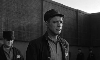 Movie still from “Birdman of Alcatraz” (1962), directed by John Frankenheimer – Black and white photograph of a man wearing a hat; Medium shot, Low angle