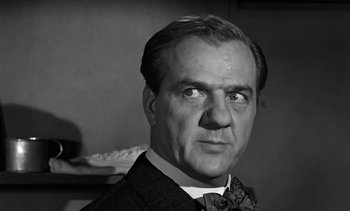 Movie still from “Birdman of Alcatraz” (1962), directed by John Frankenheimer – An older man wearing a suit and a bow tie; Close Up shot, Low angle