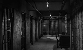 Movie still from “Birdman of Alcatraz” (1962), directed by John Frankenheimer – A black and white photo of a jail cell; Wide shot, High angle
