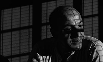 Movie still from “Birdman of Alcatraz” (1962), directed by John Frankenheimer – A black and white photo of a man with a mask on; Close Up shot, Low angle