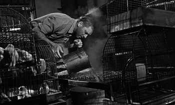 Movie still from “Birdman of Alcatraz” (1962), directed by John Frankenheimer – A man is working in an industrial setting; Medium shot, Low angle