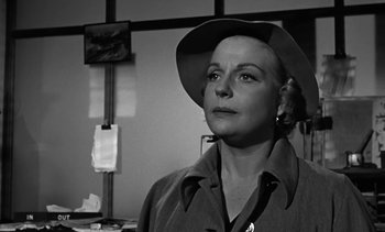 Movie still from “Birdman of Alcatraz” (1962), directed by John Frankenheimer – A woman wearing a hat looking to her left; Close Up shot, Low angle