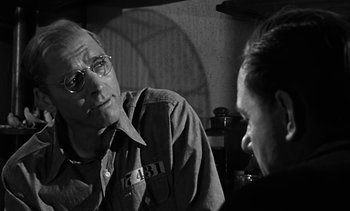 Movie still from “Birdman of Alcatraz” (1962), directed by John Frankenheimer – A black and white photo of a man talking to another man; Close Up shot, Over the shoulder angle