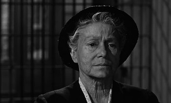 Movie still from “Birdman of Alcatraz” (1962), directed by John Frankenheimer – An older woman wearing a hat and looking at the camera; Close Up shot, Low angle