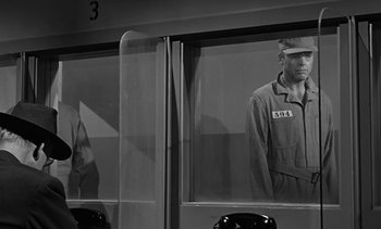 Movie still from “Birdman of Alcatraz” (1962), directed by John Frankenheimer – A black and white photo of a man standing in front of a window; Medium shot, Over the shoulder angle