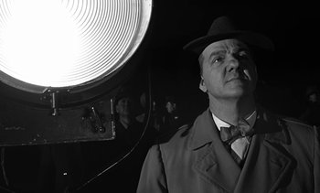 Movie still from “Birdman of Alcatraz” (1962), directed by John Frankenheimer – A black and white photo of a man in a suit and hat; Medium shot, Low angle