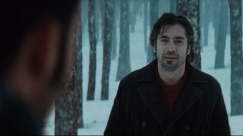 Movie still from “Biutiful” (2010), directed by Alejandro G. Iñárritu – A man standing in the snow near a forest; Close Up shot, Over the shoulder angle