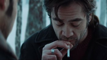 Movie still from “Biutiful” (2010), directed by Alejandro G. Iñárritu – A person smoking a cigarette; Close Up shot, Over the shoulder angle