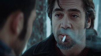 Movie still from “Biutiful” (2010), directed by Alejandro G. Iñárritu – A person smoking a cigarette; Close Up shot, Over the shoulder angle