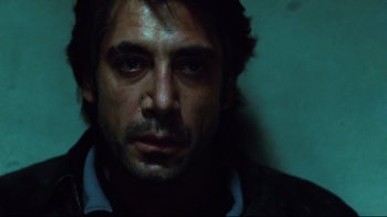 Movie still from “Biutiful” (2010), directed by Alejandro G. Iñárritu – A person wearing a suit and tie; Close Up shot, Over the shoulder angle