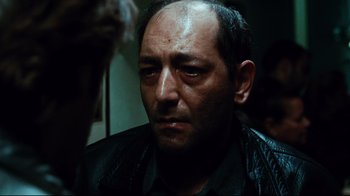 Movie still from “Biutiful” (2010), directed by Alejandro G. Iñárritu – A person wearing a leather jacket; Close Up shot, High angle