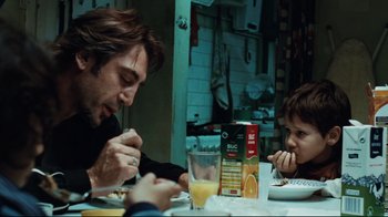 Movie still from “Biutiful” (2010), directed by Alejandro G. Iñárritu – A man and a child are sitting at a dinner table; Medium shot, Over the shoulder angle
