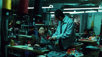 Movie still from “Biutiful” (2010), directed by Alejandro G. Iñárritu – A group of people working in a factory; Medium shot, High angle