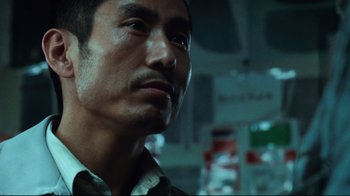 Movie still from “Biutiful” (2010), directed by Alejandro G. Iñárritu – A person looking at the camera; Close Up shot, Low angle