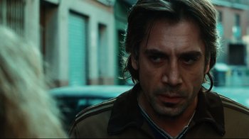 Movie still from “Biutiful” (2010), directed by Alejandro G. Iñárritu – A person wearing a brown jacket; Close Up shot, Over the shoulder angle