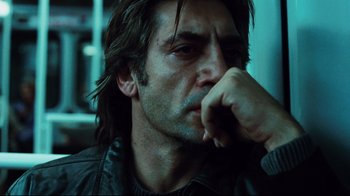 Movie still from “Biutiful” (2010), directed by Alejandro G. Iñárritu – A person with his hand to his face; Close Up shot, Low angle