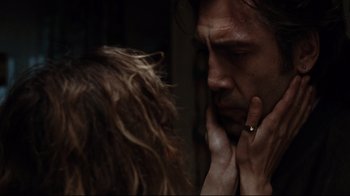 Movie still from “Biutiful” (2010), directed by Alejandro G. Iñárritu – A man and a woman face to face in a dark room; Close Up shot, Over the shoulder angle