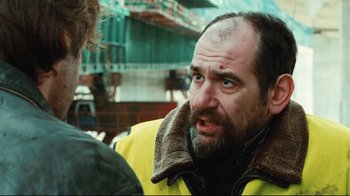 Movie still from “Biutiful” (2010), directed by Alejandro G. Iñárritu – A man with a beard talking to another man; Close Up shot, Over the shoulder angle