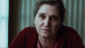 Movie still from “Biutiful” (2010), directed by Alejandro G. Iñárritu – A person wearing a red sweater; Close Up shot, Low angle