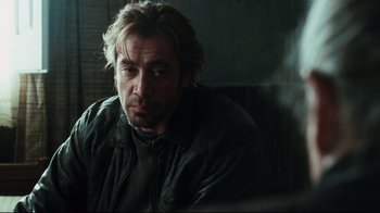 Movie still from “Biutiful” (2010), directed by Alejandro G. Iñárritu – A person sitting in a chair; Close Up shot, Over the shoulder angle
