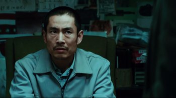 Movie still from “Biutiful” (2010), directed by Alejandro G. Iñárritu – A person sitting in a chair; Close Up shot, Over the shoulder angle