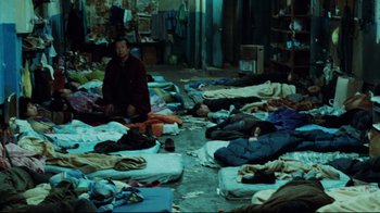 Movie still from “Biutiful” (2010), directed by Alejandro G. Iñárritu – A group of people sleeping on the floor of a room; Wide shot, High angle