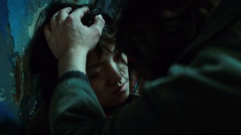 Movie still from “Biutiful” (2010), directed by Alejandro G. Iñárritu – A man is holding a woman's hair while she sleeps; Close Up shot, Over the shoulder angle