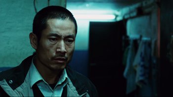 Movie still from “Biutiful” (2010), directed by Alejandro G. Iñárritu – A person wearing a jacket; Close Up shot, Low angle