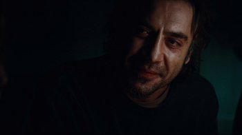 Movie still from “Biutiful” (2010), directed by Alejandro G. Iñárritu – A person in a dark room; Close Up shot, Over the shoulder angle