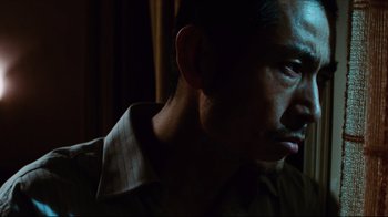 Movie still from “Biutiful” (2010), directed by Alejandro G. Iñárritu – A person wearing a brown shirt; Close Up shot, Low angle