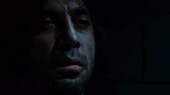 Movie still from “Biutiful” (2010), directed by Alejandro G. Iñárritu – A person's face in the dark; Close Up shot, Low angle