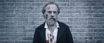 A man with blood all over his face and beard