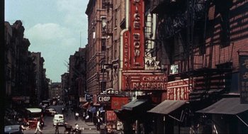 Movie still from “Black Caesar” (1973), directed by Larry Cohen – An old picture of a city street in the 1 9 5 0's; Extreme Wide shot, High angle