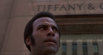 Movie still from “Black Caesar” (1973), directed by Larry Cohen – A person looking up at the sky; Close Up shot, Low angle