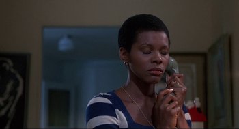 Movie still from “Black Caesar” (1973), directed by Larry Cohen – A woman holding a phone up to her ear; Close Up shot, Low angle